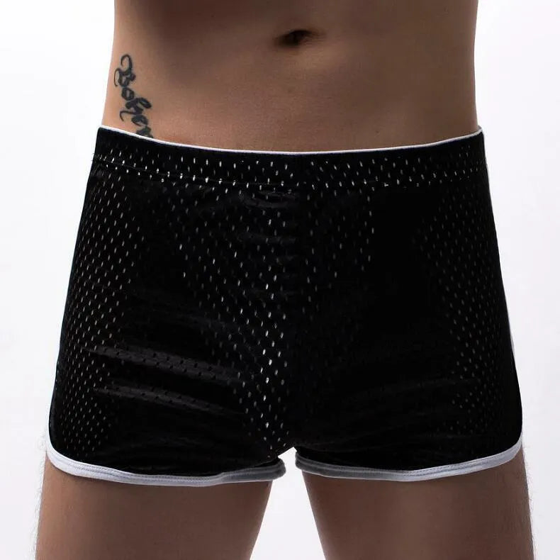 Men's grey cotton blend three-point boxer shorts laid flat, showing mid-waist design and knitted fabric texture.