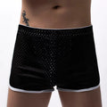 Men's grey cotton blend three-point boxer shorts laid flat, showing mid-waist design and knitted fabric texture.