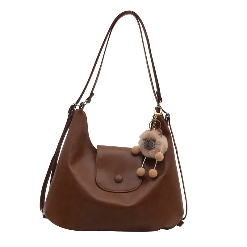 Women's PU leather shoulder bag with single strap, horizontal square design, and internal phone pouch in black colour