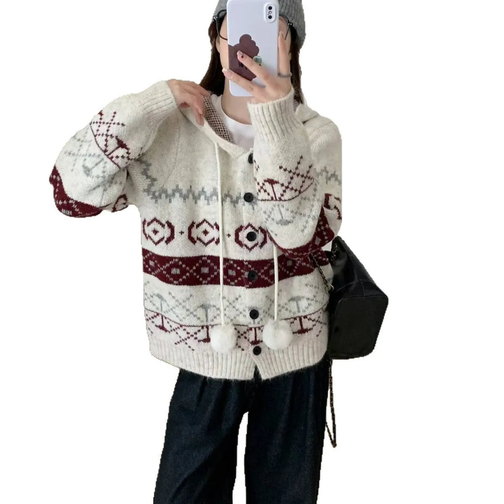 A beige, loose-fitting brocade knit sweater coat for plus size women with a geometric pattern.