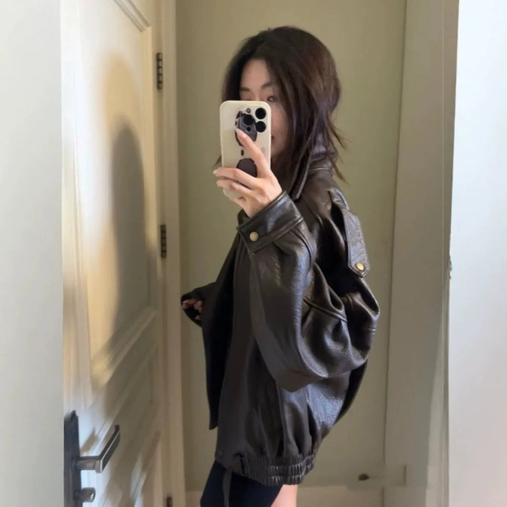 Women's loose fit brown faux leather jacket with front zipper and regular sleeves