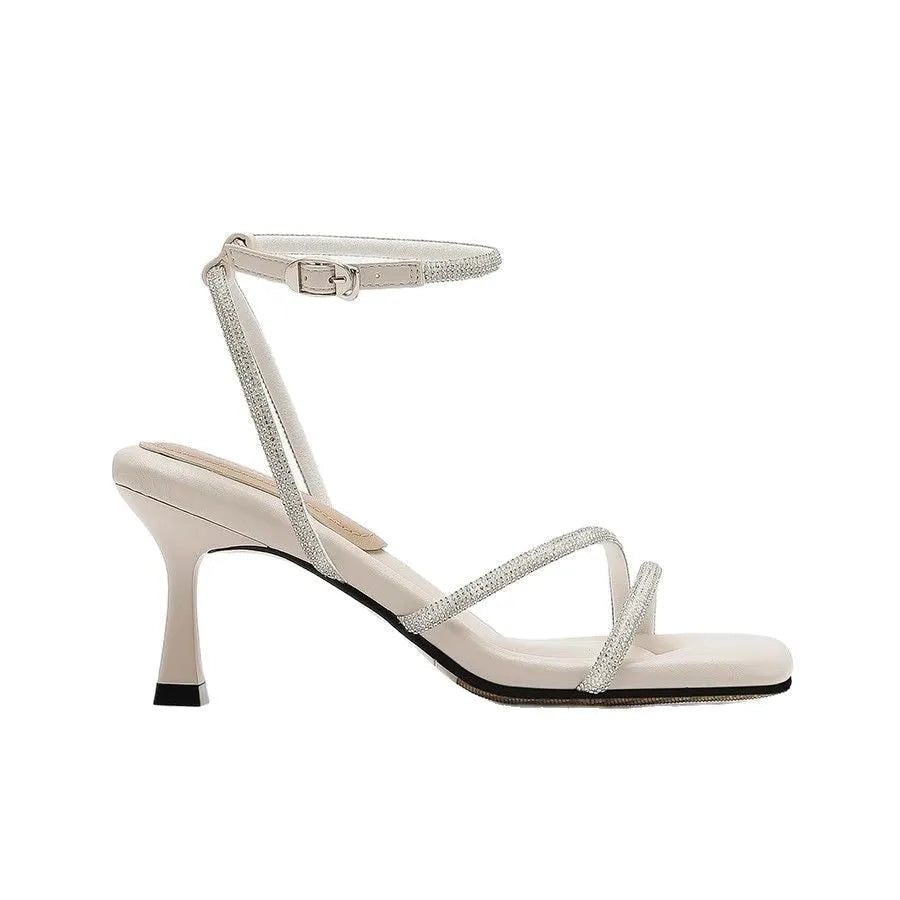 Women's silver high heel sandals with square toe, rhinestone detail, and an ankle-strap buckle.