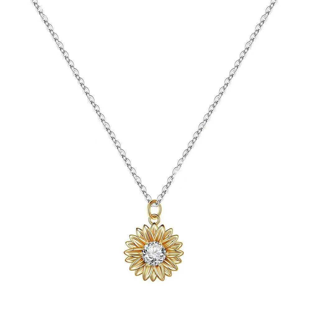 Close-up of a geometric sunflower pendant necklace on an adjustable silver cross chain.