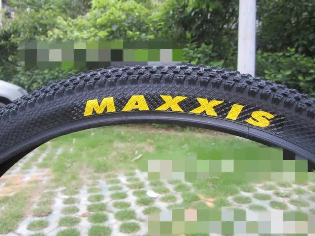 Ultralight mountain bike tyre with puncture-resistant tread, shown in a black and white sidewall style.