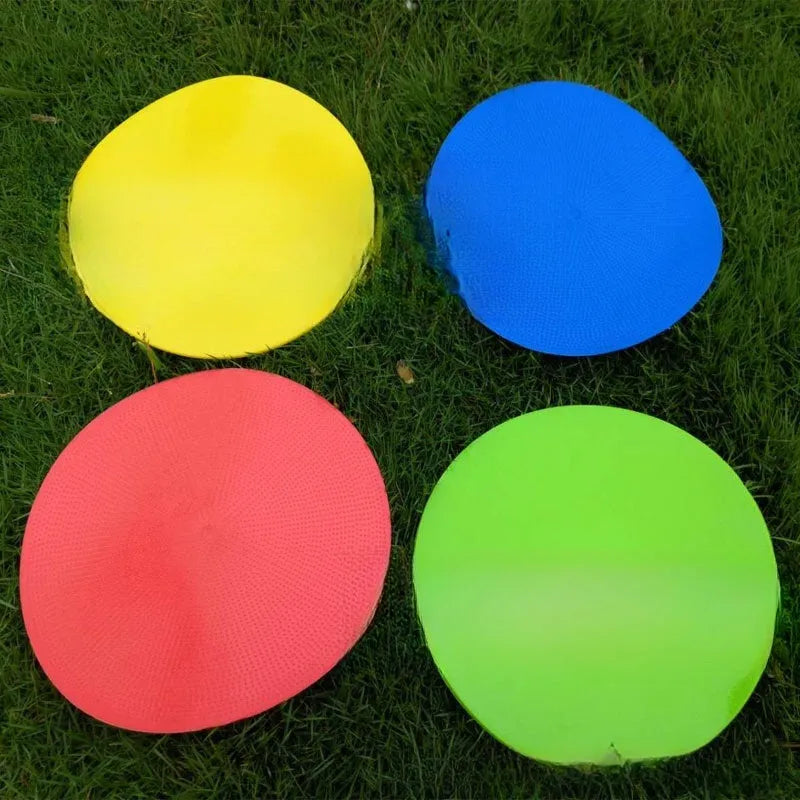 Yellow football training marker disc on grass field showing 23cm diameter flat design