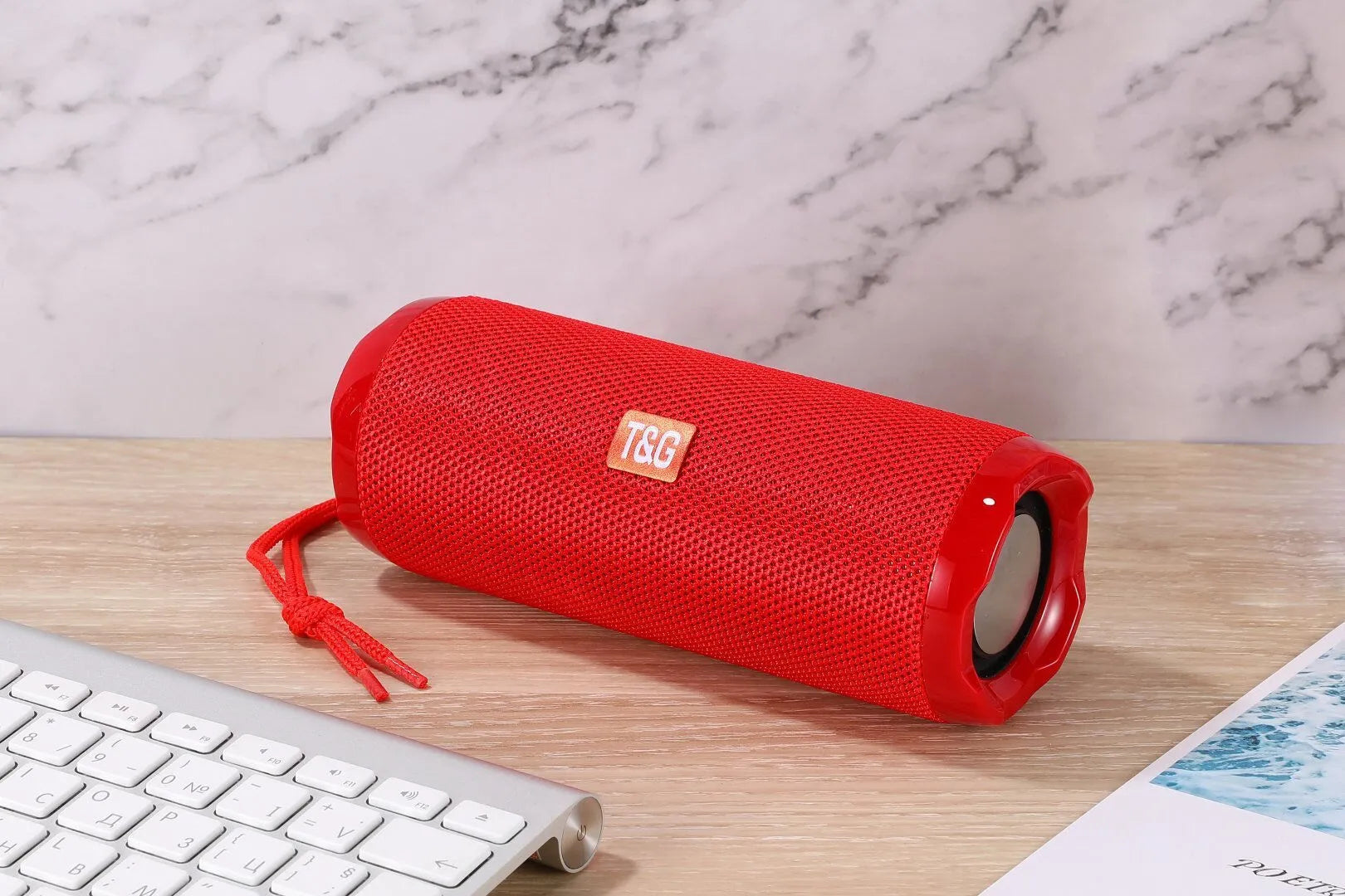Fabric-covered portable Bluetooth speaker showing the integrated card holder slot, displayed in the camouflage colour variant.