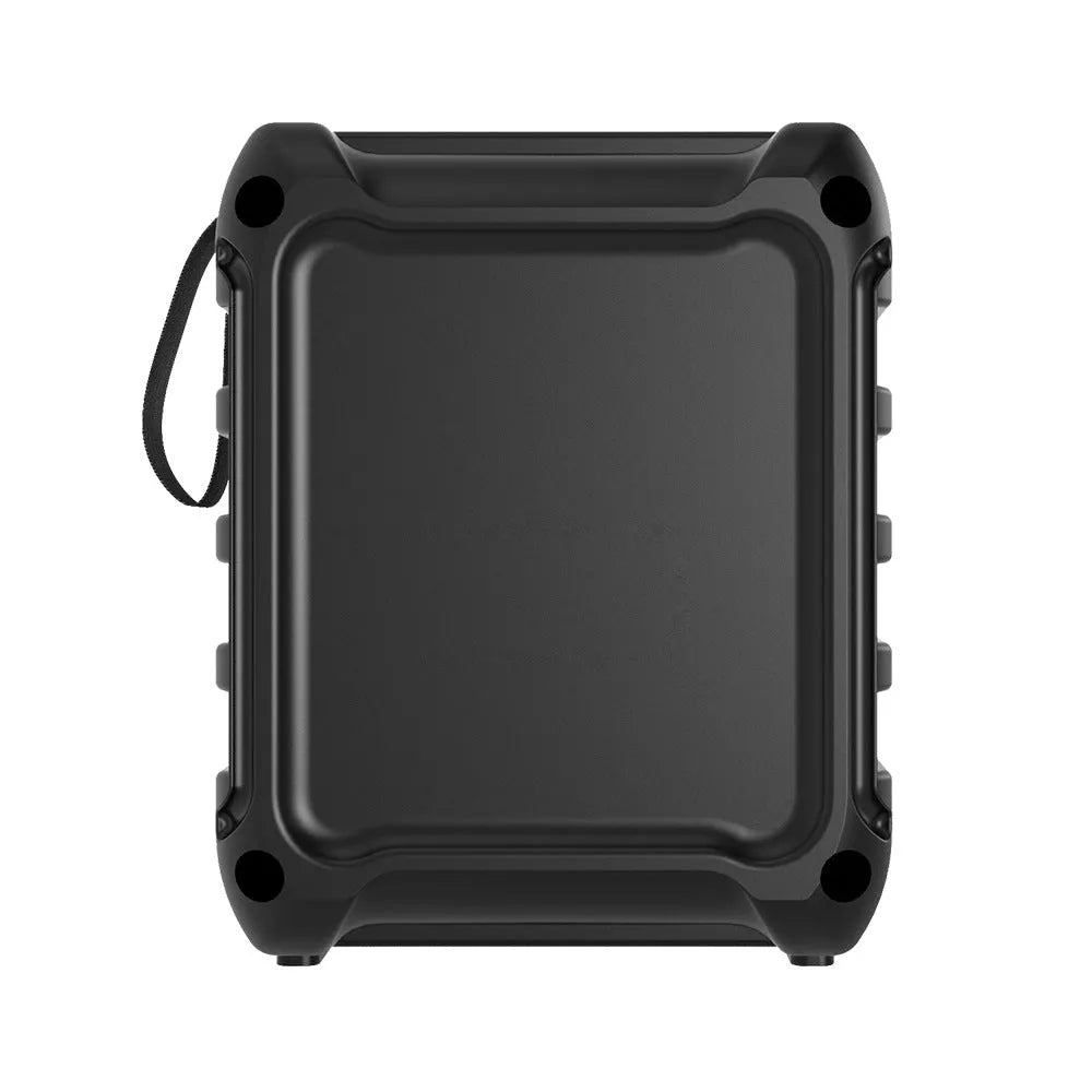 Compact rectangular portable Bluetooth speaker with USB charging cable on a desk.