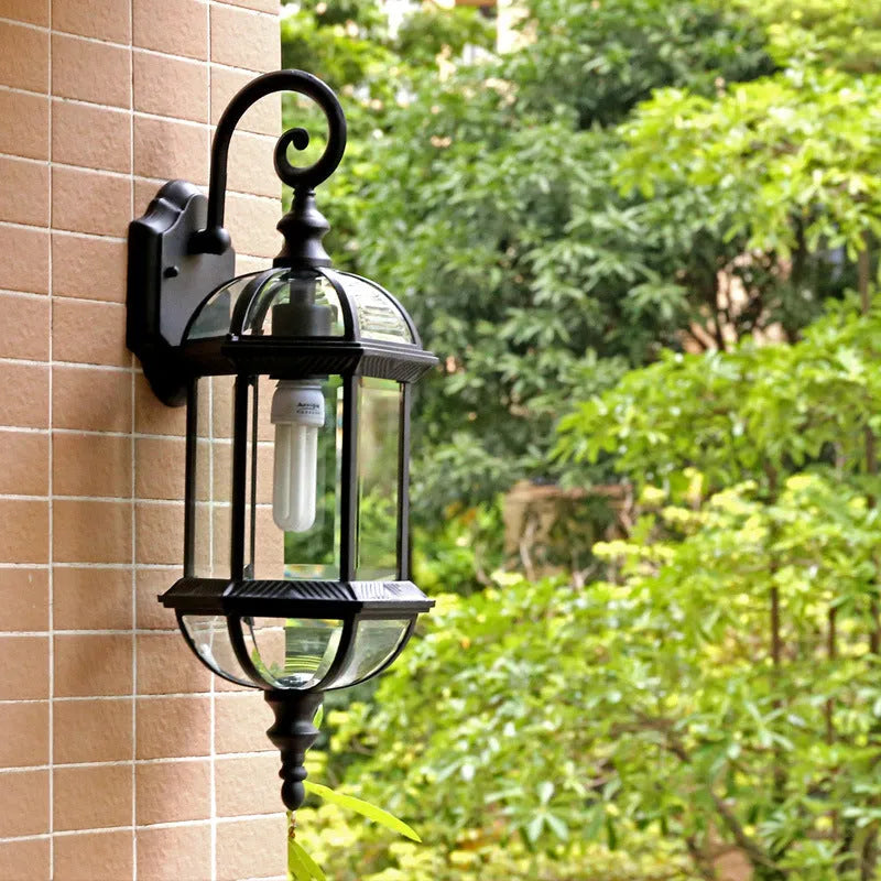 Gold and black outdoor aluminium wall lamp with a three-layer, eight-inch waterproof design.