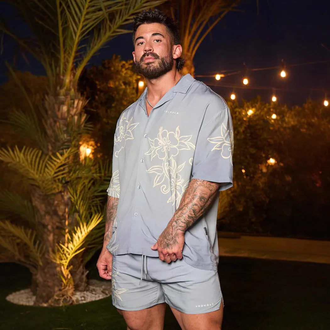 Men's loose-fit short sleeve top with floral print in light colour, laid flat.