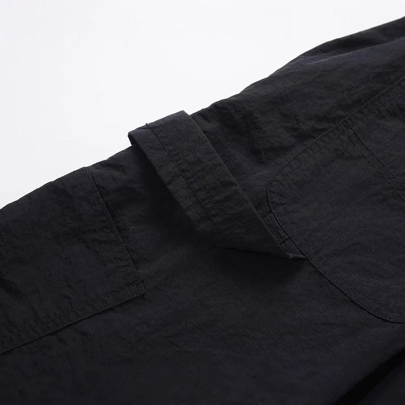 Black paratrooper pants with baggy fit and drawstring waist adjustment