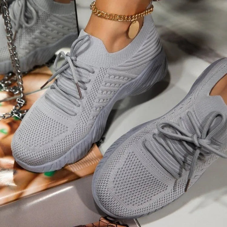 Women's chunky platform sneaker in a solid colour with a thick sole, shown from the side.