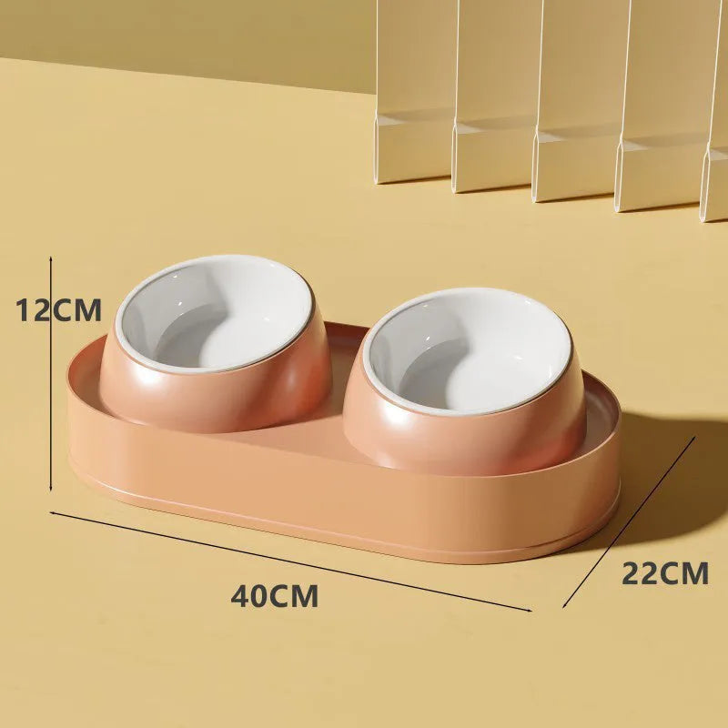White elevated pet feeder with two tilted bowls on a wide base, for cats and small dogs.