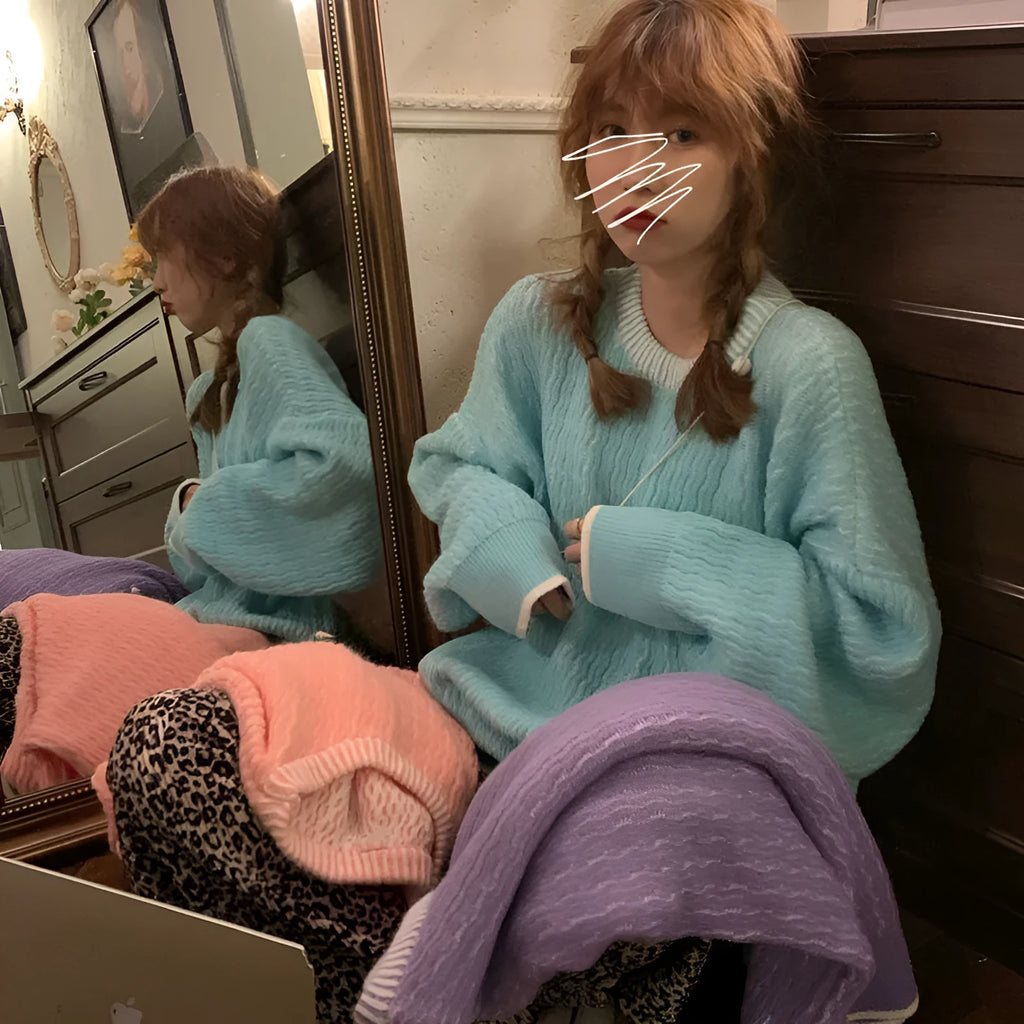 Women's loose retro pullover sweater in lake blue, shown in a casual setting.