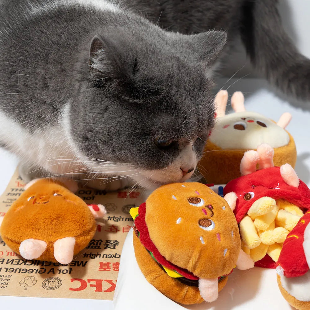 Cat chewing toy shaped like hamburger and chicken leg with catnip filling