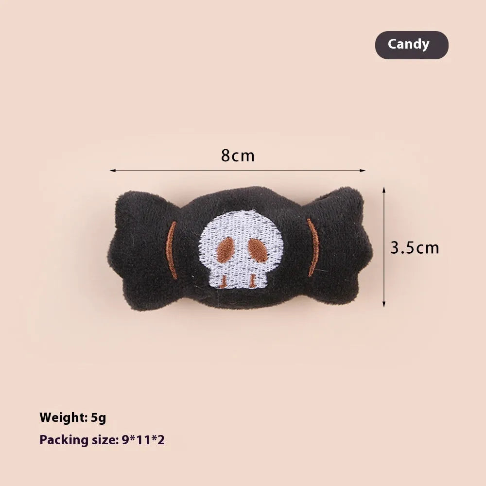 Small cat teaser wand toy with plush candy and skull attachments on string