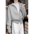 Grey Hong Kong style double zipper knitted cardigan with floral pattern on a hanger.