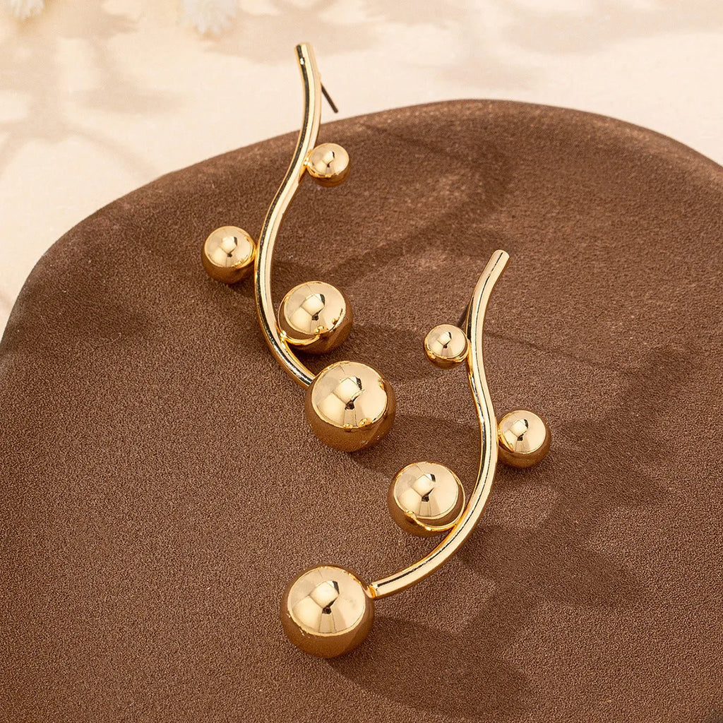 Pair of golden yellow round ball stud earrings made from iron in a popular size