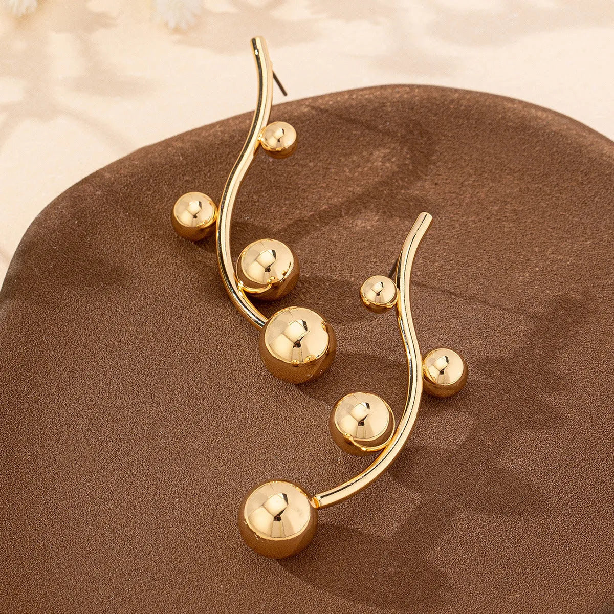 Pair of golden yellow round ball stud earrings made from iron in a popular size