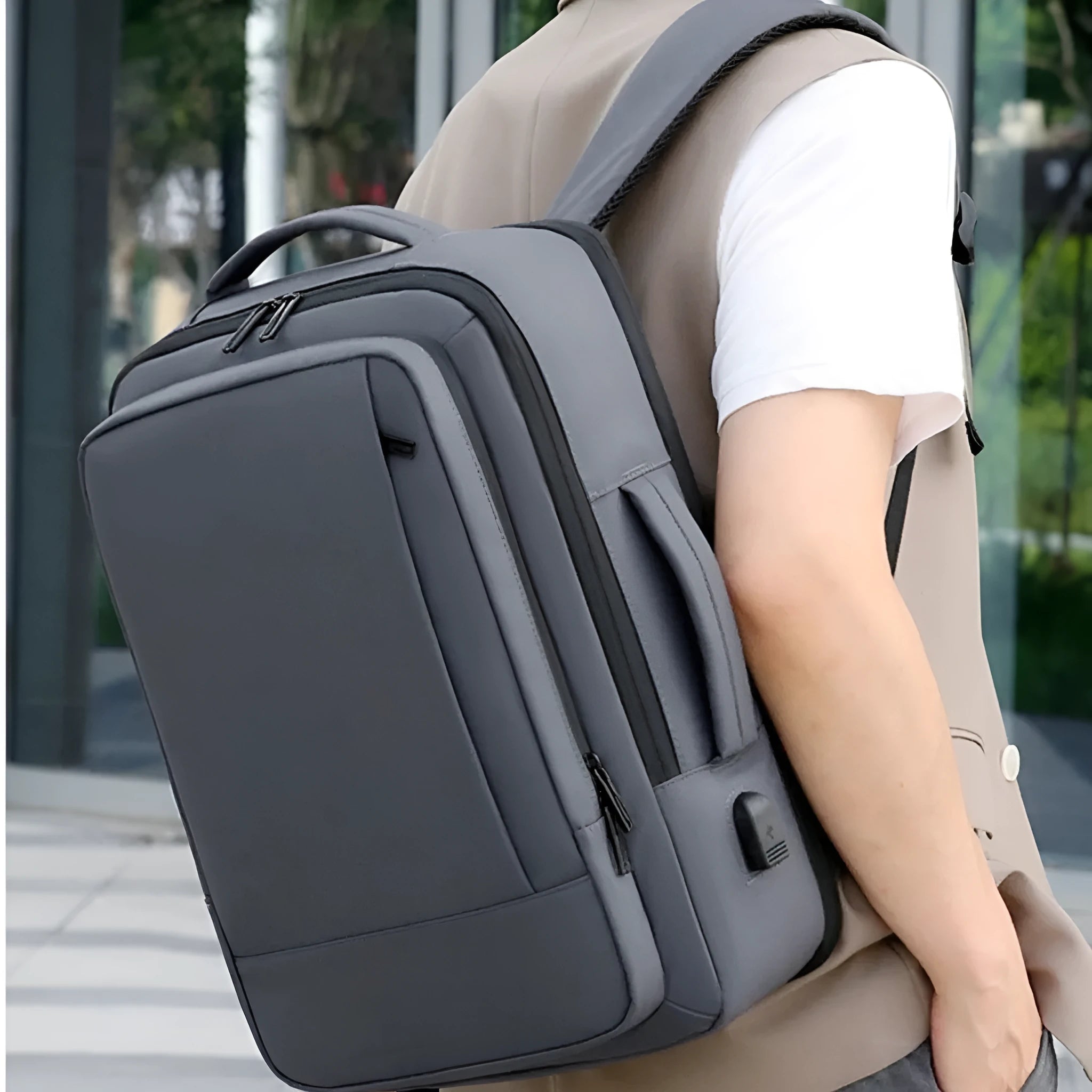 Black waterproof Oxford cloth backpack with curved shoulder strap showing 20-35L capacity for business travel