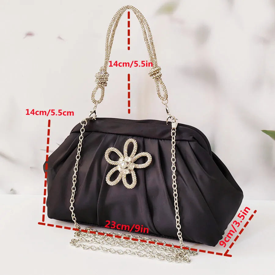Soft shell-shaped lavender purple women's shoulder bag with fold, diamond, and chain details.