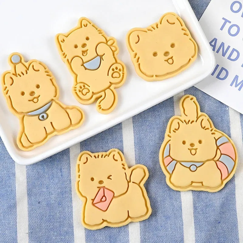 Three-dimensional plastic biscuit mould set with puppy cartoon designs including birthday hats and swimming rings