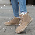 Black unisex waterproof winter snow boots with fleece lining and rubber sole on a wet surface.