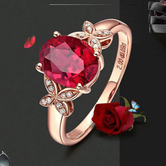 Women's butterfly-shaped ring with heart crystal in rose gold plating on blue or red background