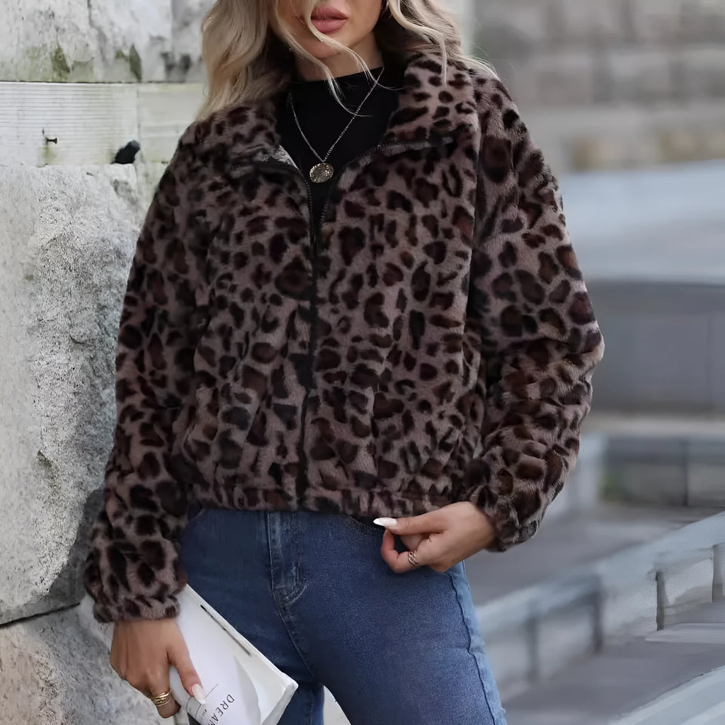 A woman's loose-fitting, zip-front plush coat in a leopard print pattern with raglan sleeves.