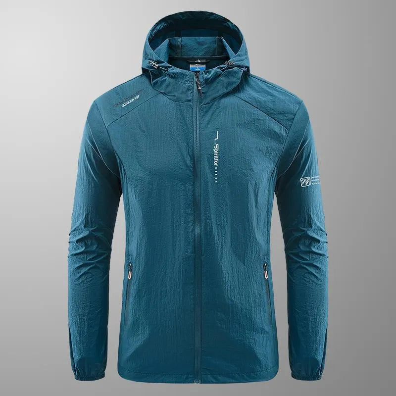 Man wearing a light grey loose-fit hooded nylon summer jacket outdoors.
