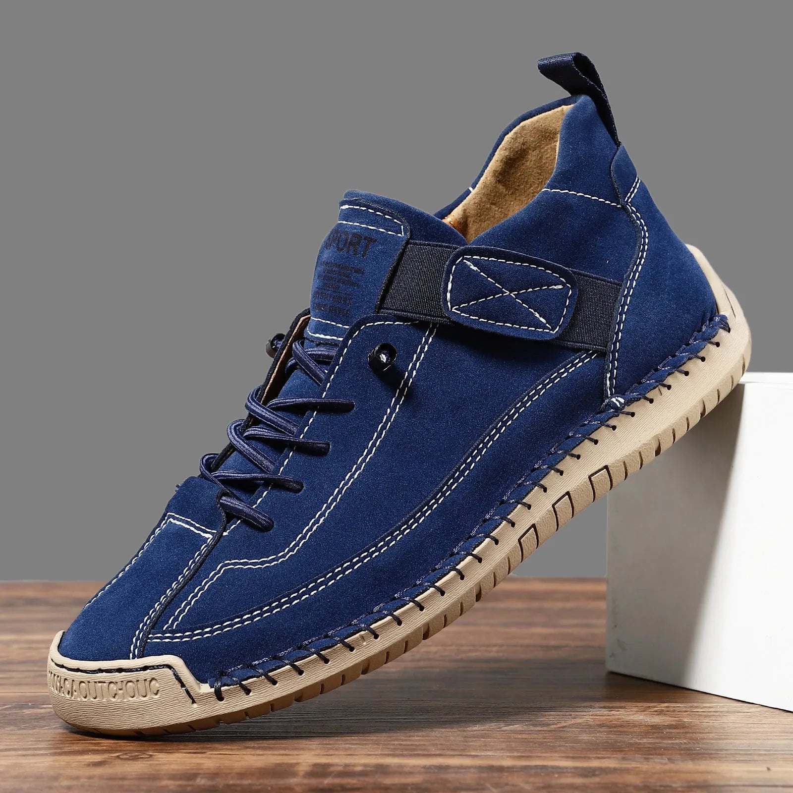 Men's mid-calf Martin boots in khaki with visible tooling stitching and an elastic band across the instep.