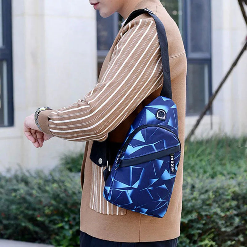 Men's blue crossbody sling bag with an earphone hole and zipper pocket.