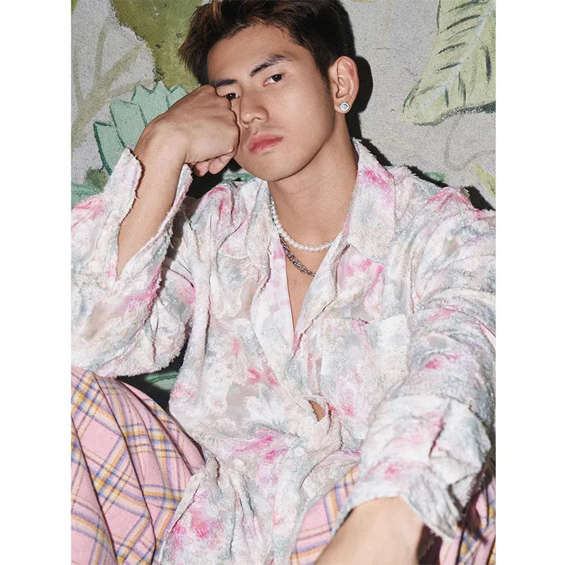 Women's pink embossed floral long sleeve loose-fit shirt on a hanger.