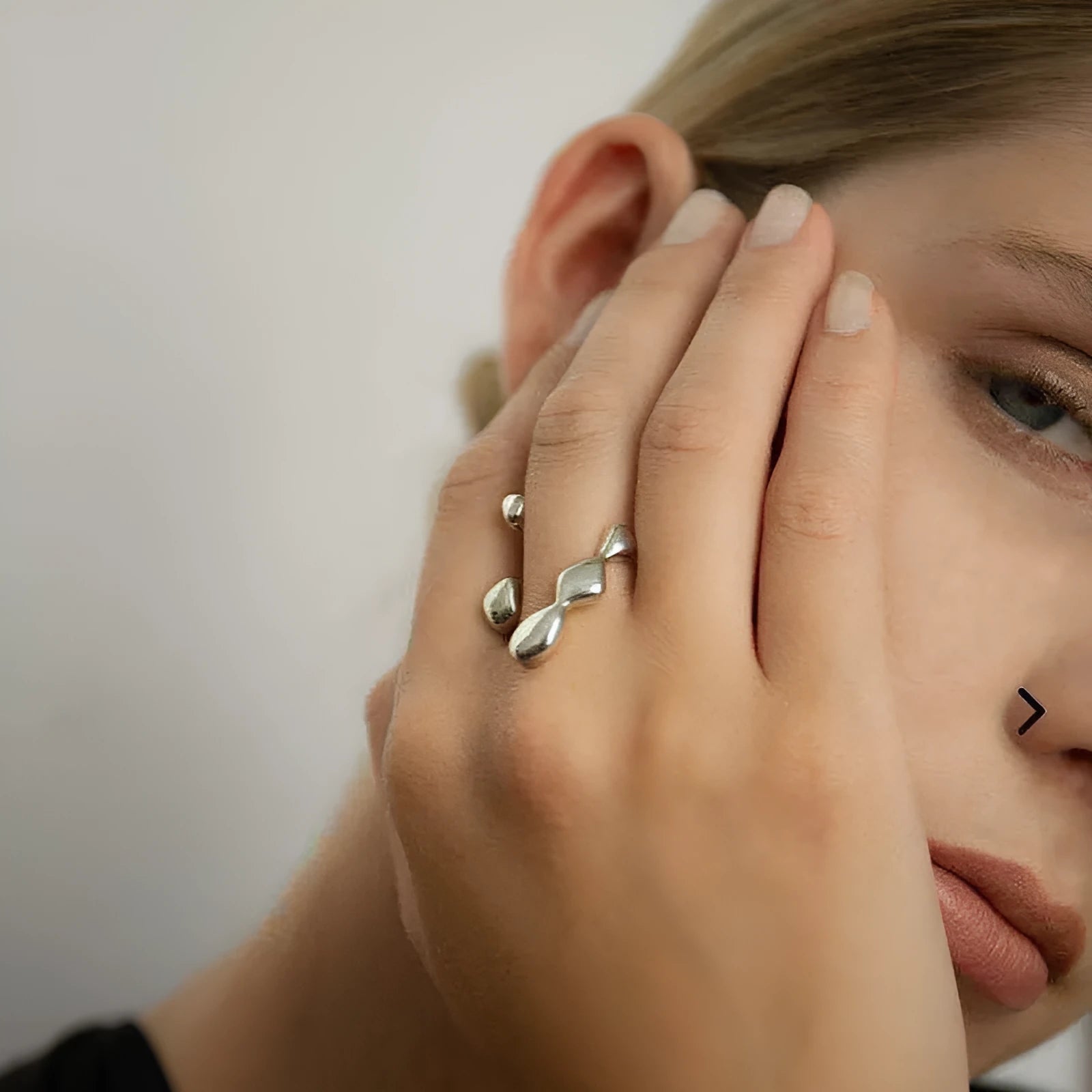 Brass spherical ring for women in gold or silver colour on a circular band.
