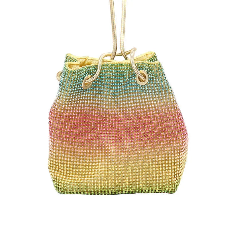 Soft rainbow rhinestone bucket handbag with adjustable long strap on a neutral background.
