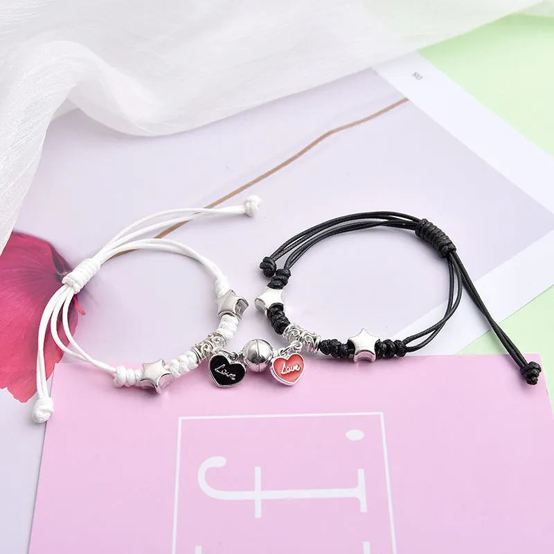 Magnet suction couple bracelets with alloy construction and various pendant designs including crowns and hearts