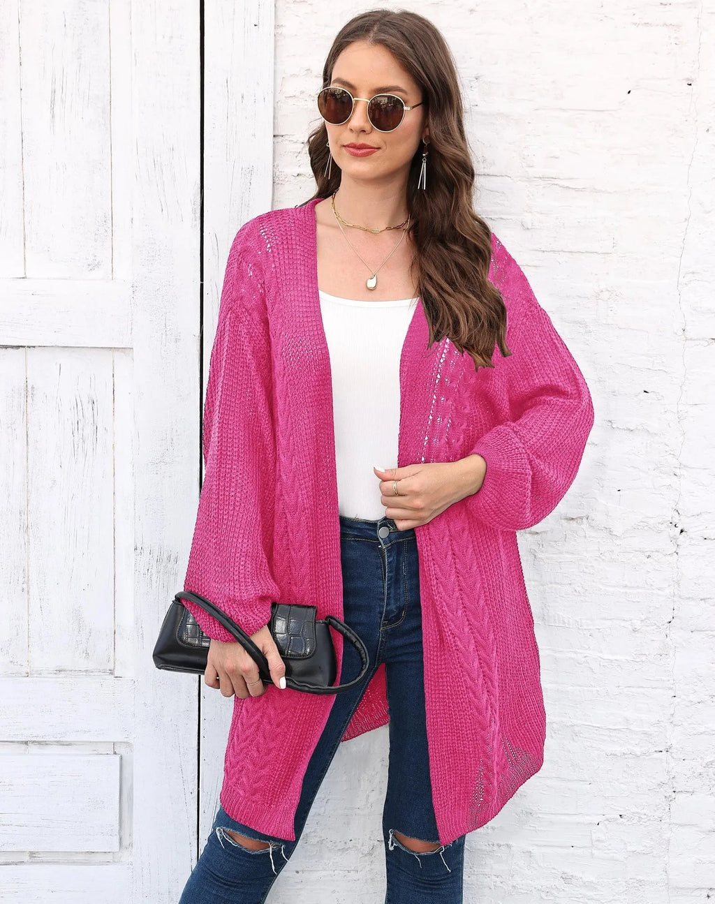 Women's loose acrylic sweater coat in a solid colour, shown in a casual style.