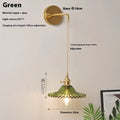 Retro brass lotus wall lamp with glass shade mounted on a beige wall, showcasing its copper arm and layered design.