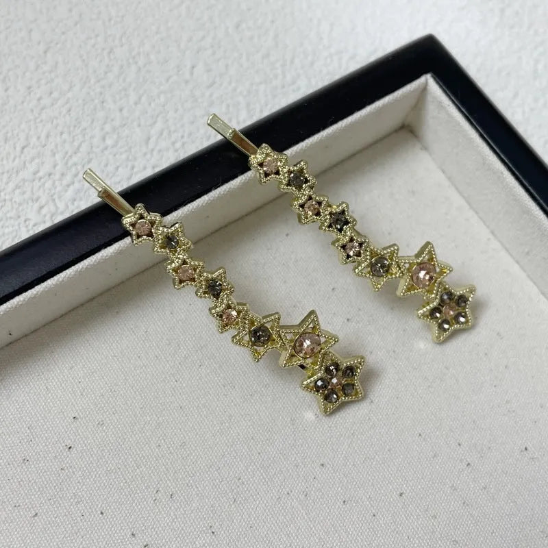Gold electroplated alloy hair barrette with side clip and five-pointed star charm decoration