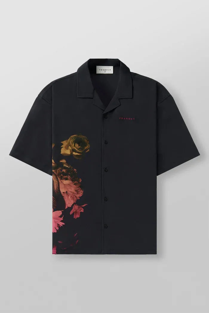 Men's loose-fit short sleeve top with floral print in light colour, laid flat.