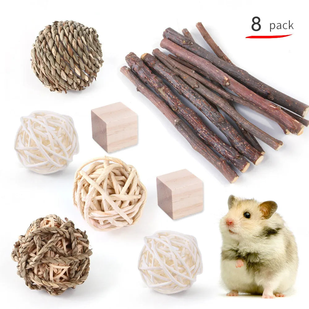 Assortment of natural wooden and woven grass chew toys for small pets like rabbits and guinea pigs