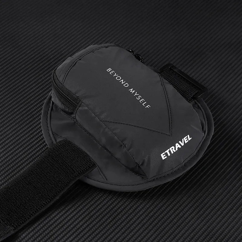 Black reflective running arm bag with adjustable strap, shown on a runner's arm at dusk.