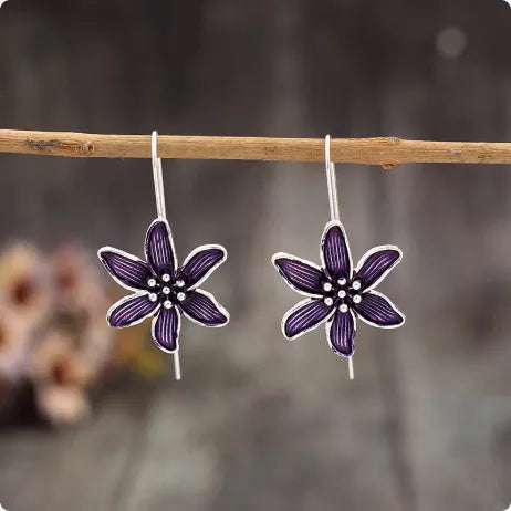 A pair of purple retro flower-shaped alloy earrings with an electroplated finish.