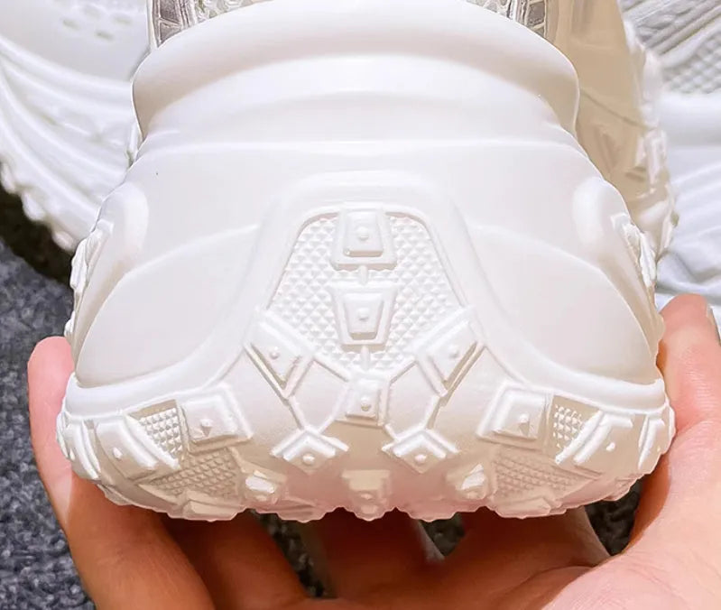 White women's lace-up dad shoes with a round toe and chunky sole for height increase.