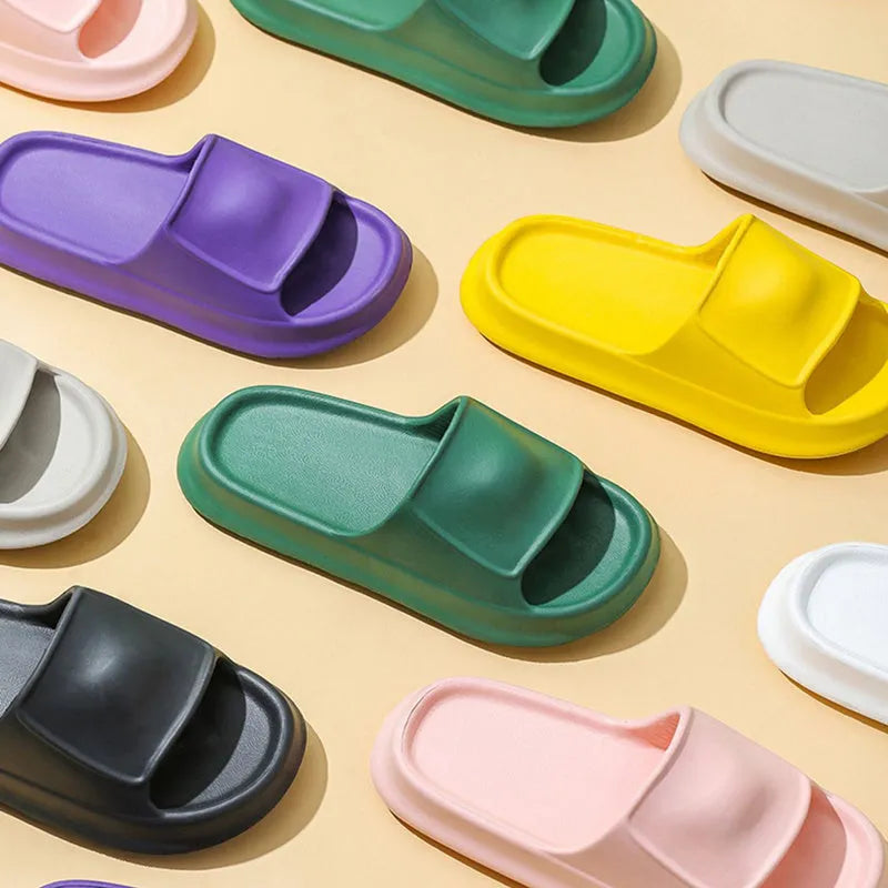A pair of thick-soled EVA flip-flop slippers on a bathroom floor, showcasing non-slip tread and available colour options.