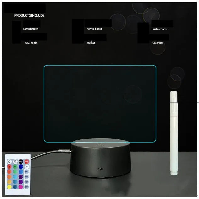 Black 3D acrylic message board night light with remote control and stylus on desk.