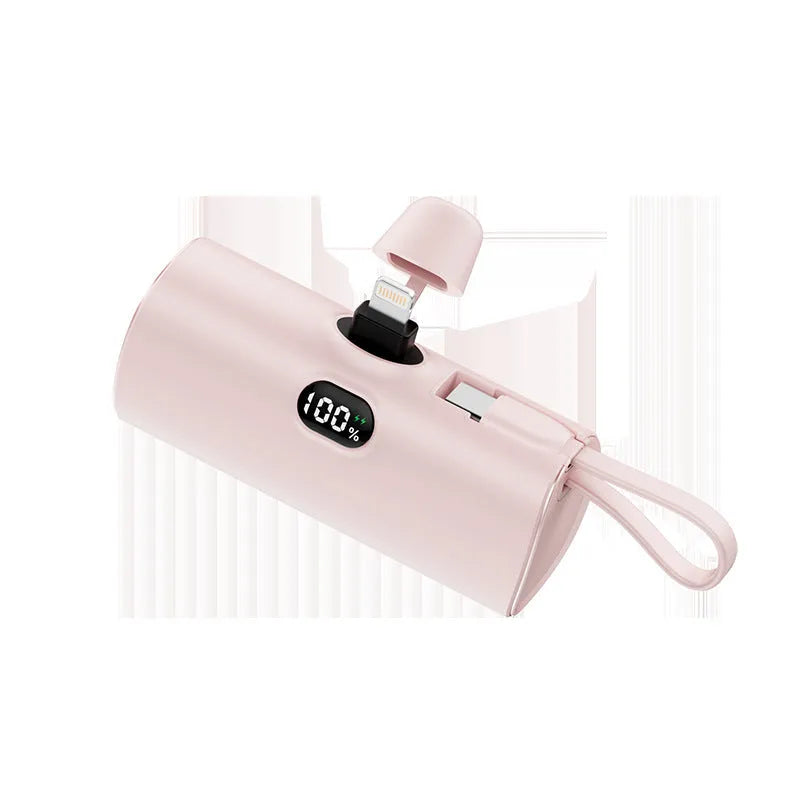 Capsule shaped digital display wireless power bank in multiple colours showing its compact size and built-in plug.