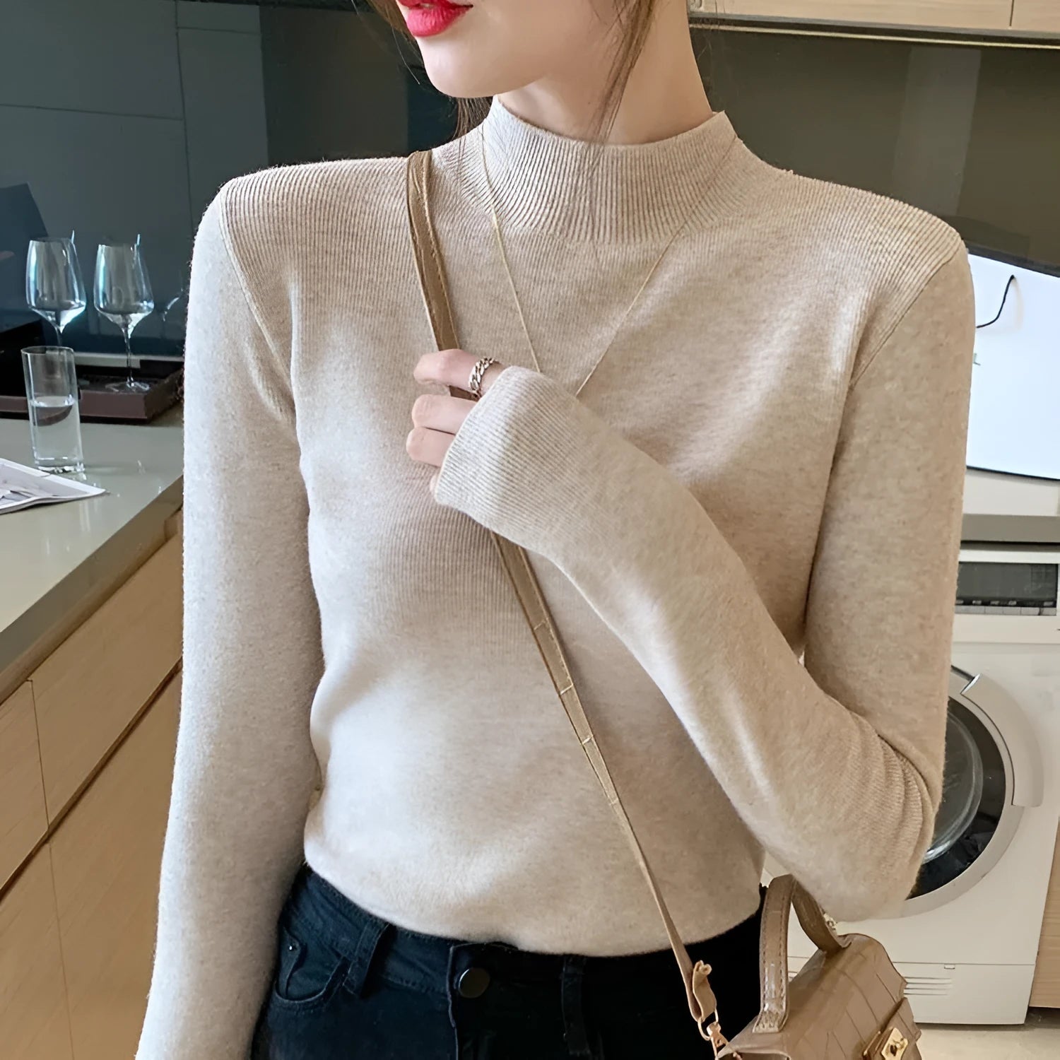 Slim fit apricot coloured viscose fibre knitted inner shirt with long sleeves laid flat.