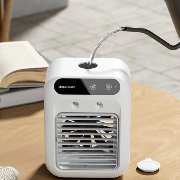 Ivory white portable air cooler with touchscreen panel and USB cable on a desk