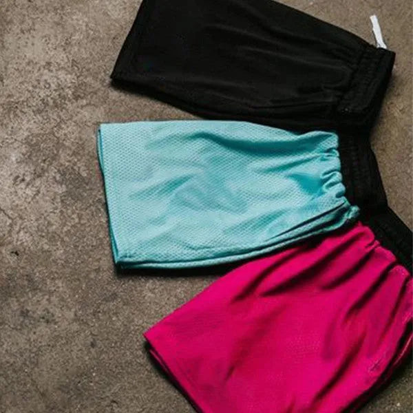 Men's solid colour quick-drying mesh sports shorts in black, shown for running.