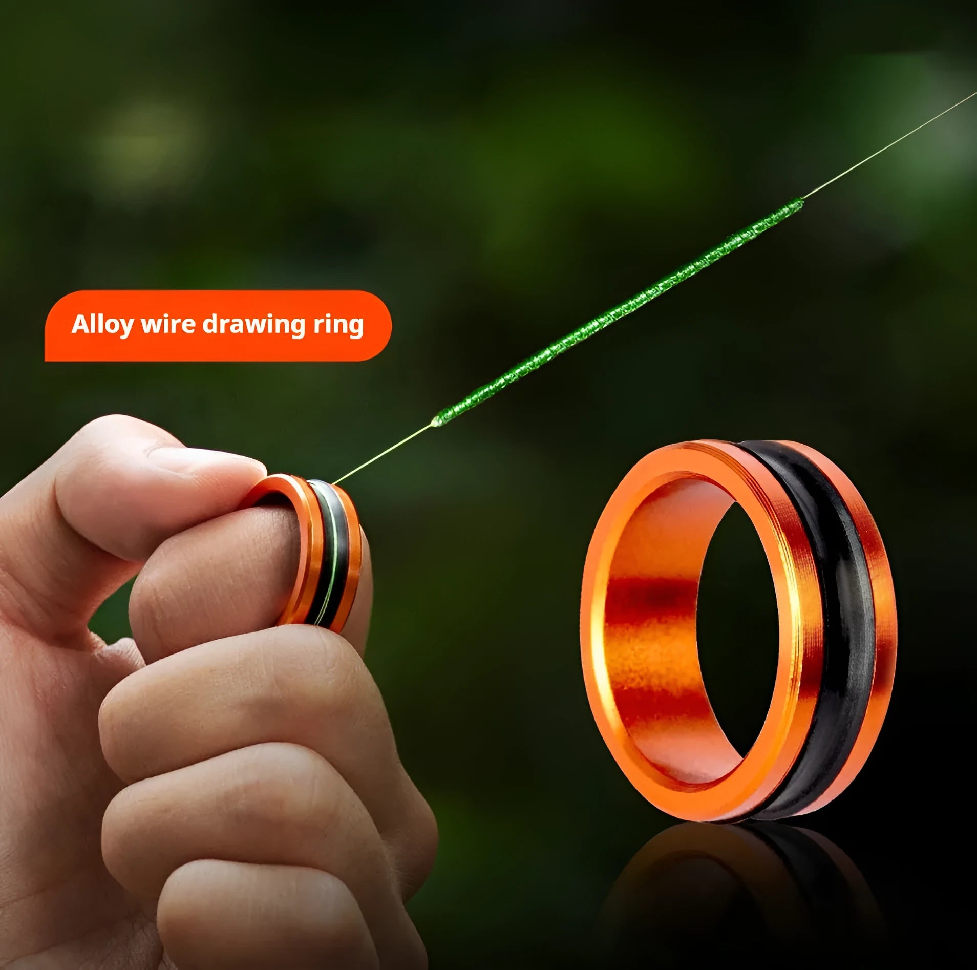 Orange and silver alloy fishing hand guard tool with a non-slip pull loop.